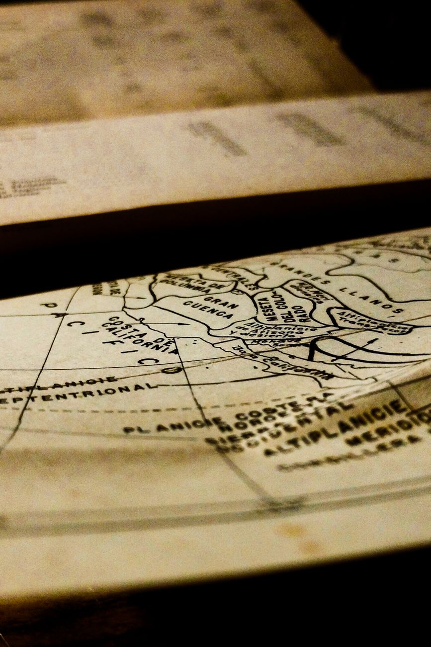 Old atlas map with a grid of meridians and parallels drawn in faded ink
