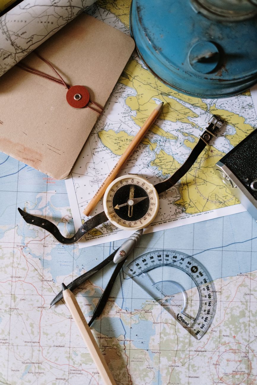 Close-up of a surveying compass dial, the needle pointing north